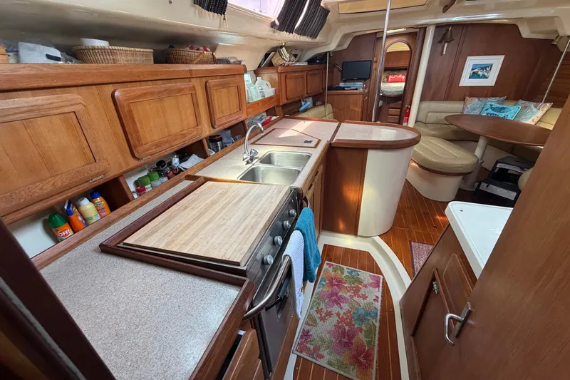 Slide: The Image of Interior of 1992 Hunter Legend 43 yacht with wooden cabinetry and cozy seating area. - 30
