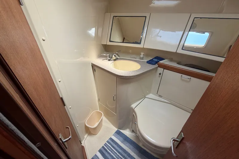 Slide: The Image of Bathroom interior of 1992 Hunter Legend 43 yacht, featuring sink, toilet, and mirror. - 47