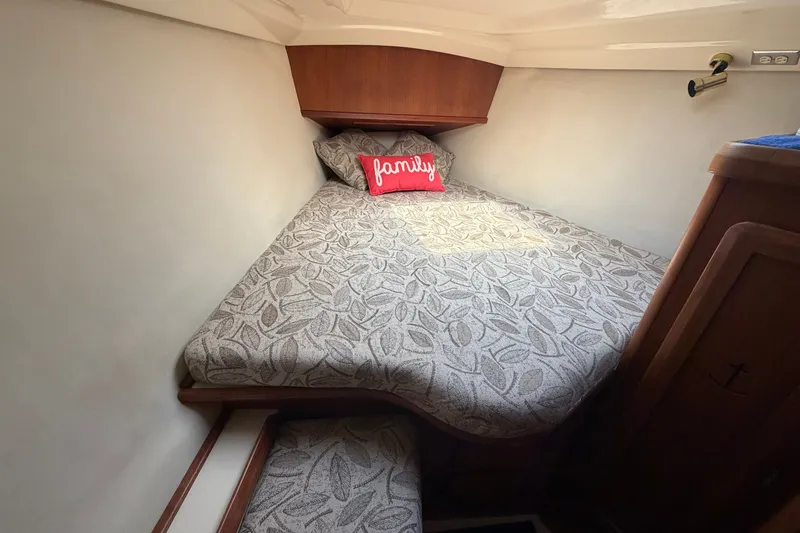 Slide: The Image of Cozy cabin interior of 1992 Hunter Legend 43 sailboat with patterned bedding and "family" pillow. - 42