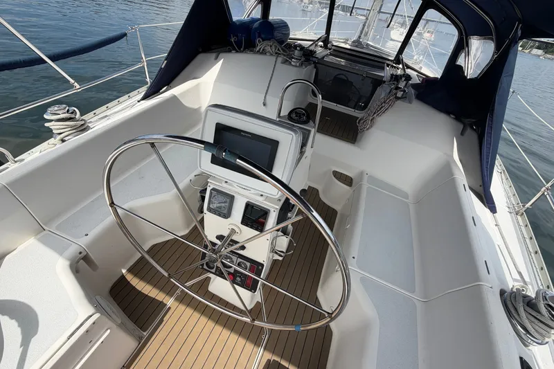 Slide: The Image of Cockpit of 1992 Hunter Legend 43 sailboat with steering wheel and navigation equipment. - 14