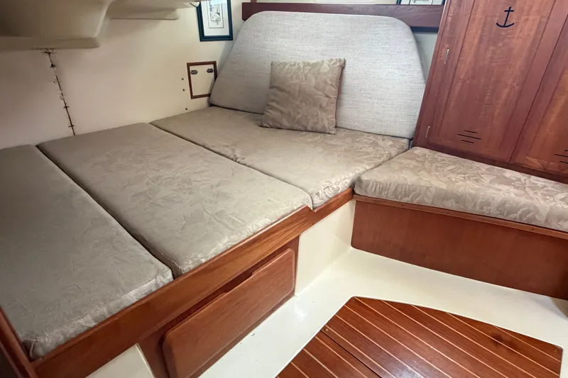 Slide: The Image of Cozy cabin interior of 1992 Hunter Legend 43 sailboat with cushioned seating. - 55