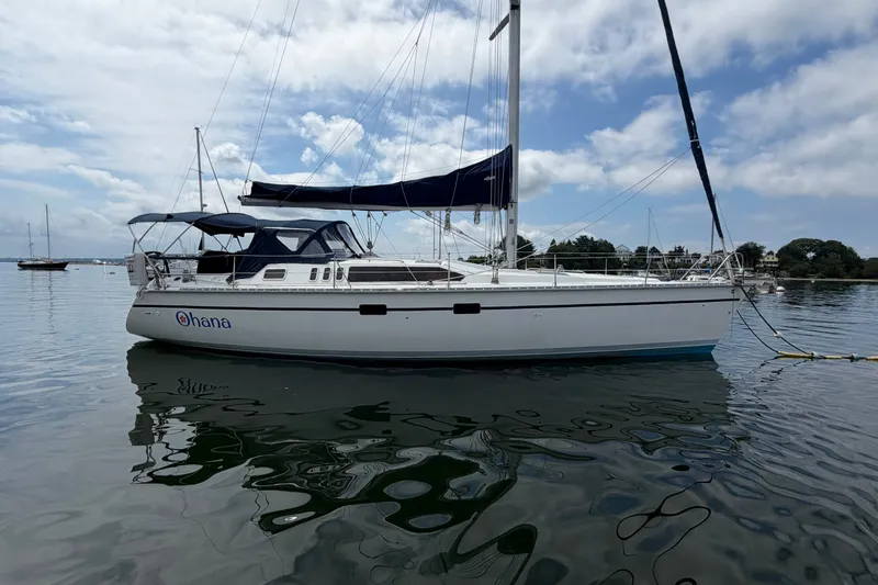 Slide: The Image of Hunter Legend 43 sailboat from 1992 on calm water under a partly cloudy sky. - 6