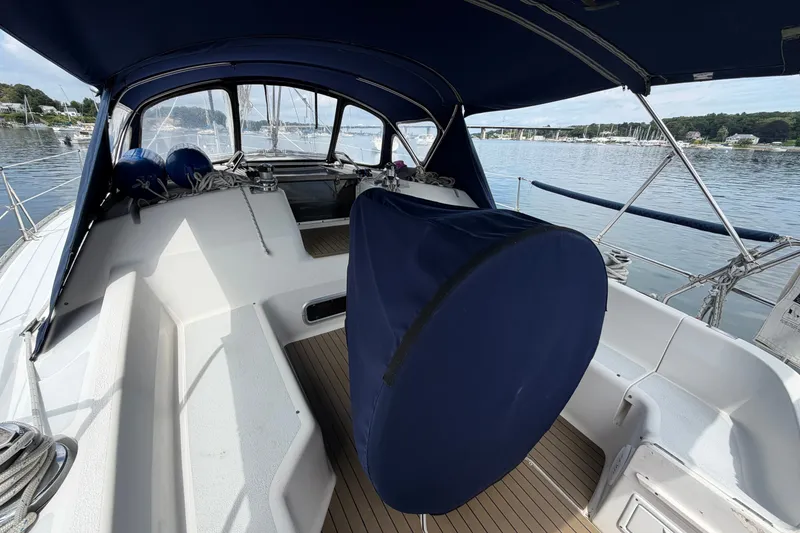 Slide: The Image of Cockpit of 1992 Hunter Legend 43 sailboat with blue canopy and marina view. - 9