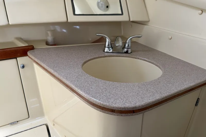 Slide: The Image of 1992 Hunter Legend 43 yacht bathroom sink with beige countertop and chrome faucet. - 52