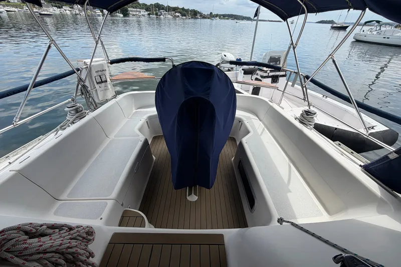 Slide: The Image of Cockpit of 1992 Hunter Legend 43 sailboat with covered steering wheel, docked on calm water. - 11