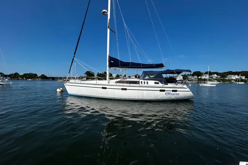 Slide: The Image of Hunter Legend 43 sailboat from 1992 on calm water under clear blue sky. - 1