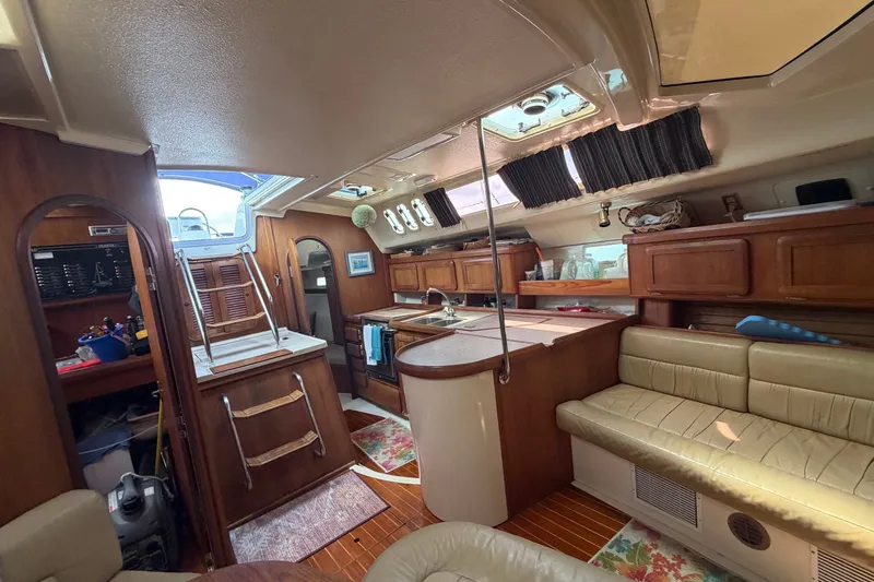 Slide: The Image of Interior of 1992 Hunter Legend 43 sailboat with wood cabinetry and cozy seating area. - 32