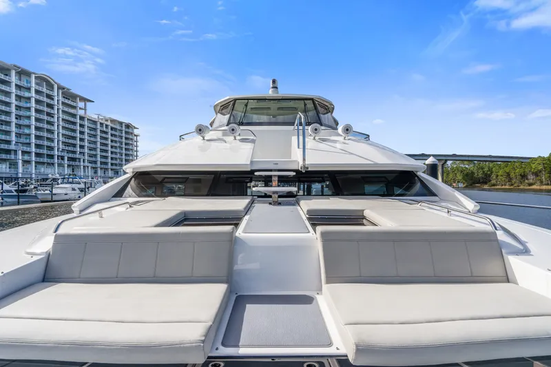 Slide: The Image of Aquila 54 Yacht 2021, luxurious deck view, docked near modern waterfront buildings. - 35
