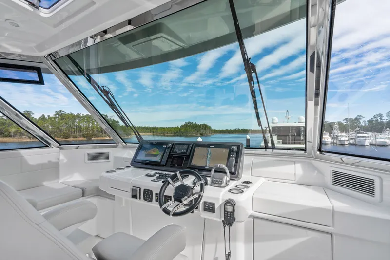 Slide: The Image of Cockpit of 2021 Aquila 54 Yacht with modern navigation equipment and scenic marina view. - 38
