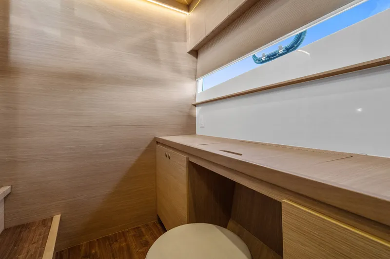 Slide: The Image of Modern interior of 2021 Aquila 54 Yacht with wooden desk and window view. - 22