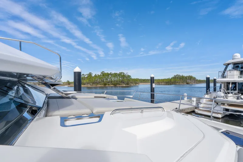 Slide: The Image of Aquila 54 Yacht 2021 docked, showcasing sleek design and serene waterfront view. - 36