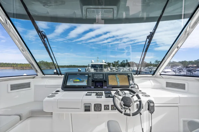 Slide: The Image of Cockpit view of 2021 Aquila 54 Yacht with navigation screens and steering wheel. - 39