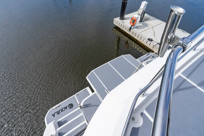 Slide: The Image of Aquila 54 Yacht 2021 docked, showing sleek deck design and water view. - 46