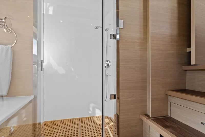 Slide: The Image of Luxurious bathroom interior of 2021 Aquila 54 Yacht with modern shower and wooden accents. - 20