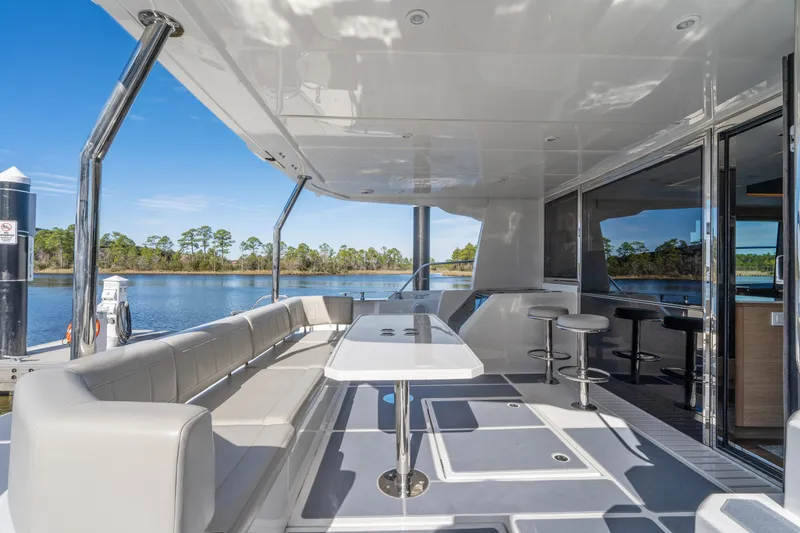 Slide: The Image of Luxurious 2021 Aquila 54 Yacht deck with seating and scenic water view. - 49