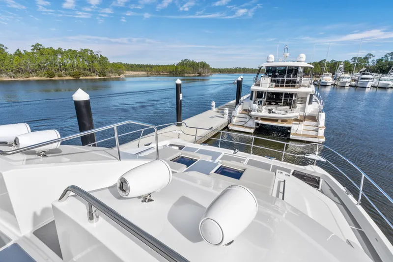 Slide: The Image of Aquila 54 Yacht 2021 docked in serene marina with clear blue skies. - 37