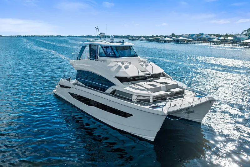 Slide: The Image of Aquila 54 Yacht 2021 cruising on a sunny day, showcasing sleek design and luxury. - 58