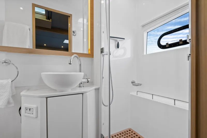 Slide: The Image of Luxurious bathroom interior of 2021 Aquila 54 Yacht with modern fixtures and ocean view. - 29