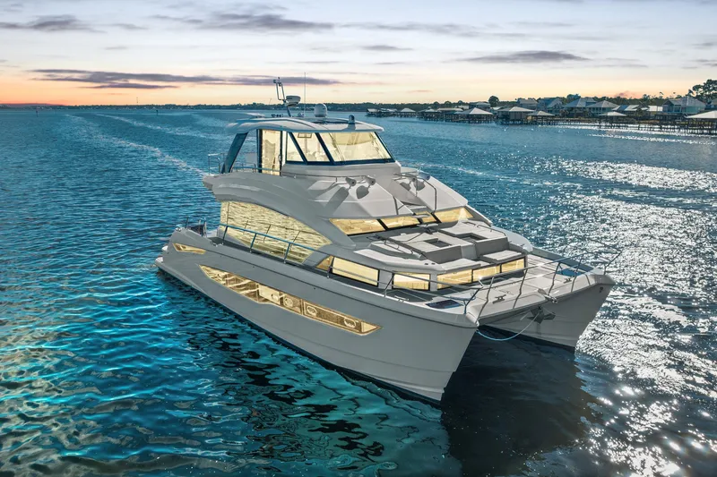 Slide: The Image of Aquila 54 Yacht 2021 cruising on serene waters at sunset. - 60
