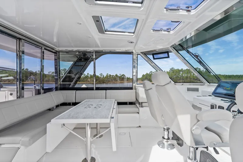 Slide: The Image of Luxurious interior of 2021 Aquila 54 Yacht with modern seating and panoramic windows. - 40