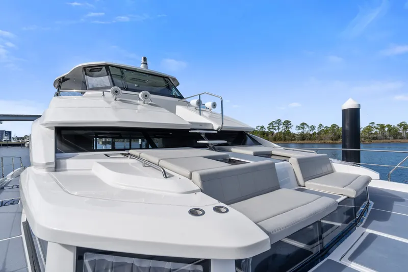Slide: The Image of Aquila 54 Yacht 2021 with sleek design and spacious deck, docked by the water. - 34