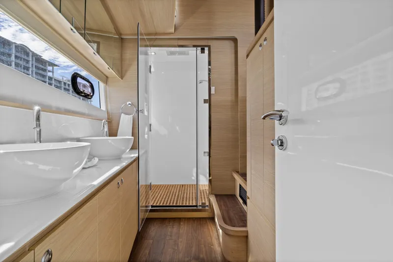 Slide: The Image of Luxurious bathroom interior of 2021 Aquila 54 Yacht with dual sinks and glass shower. - 19