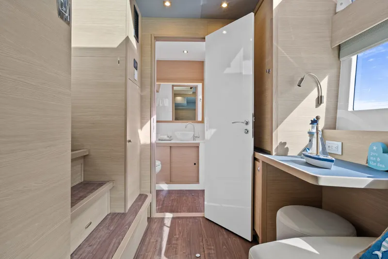 Slide: The Image of Interior of 2021 Aquila 54 Yacht featuring modern bathroom and cozy seating area. - 24