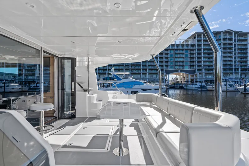 Slide: The Image of Luxurious 2021 Aquila 54 Yacht deck with modern seating and marina view. - 50