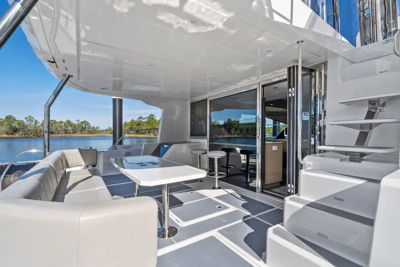 Slide: The Image of Luxurious 2021 Aquila 54 Yacht interior with elegant seating and scenic water view. - 48