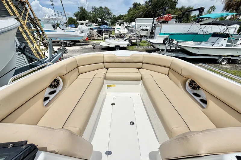Slide: The Image of 2019 NauticStar 243 DC boat interior with beige seating and speaker system. - 12