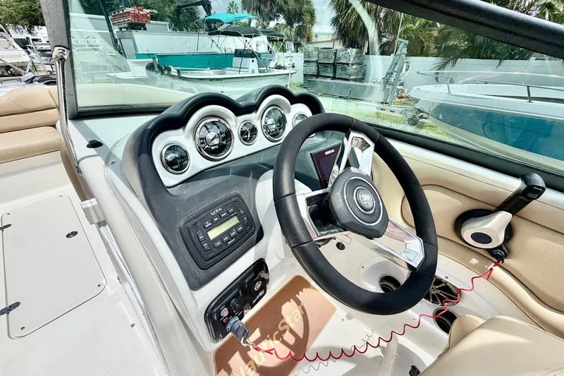 Slide: The Image of 2019 NauticStar 243 DC boat dashboard with steering wheel and gauges. - 11