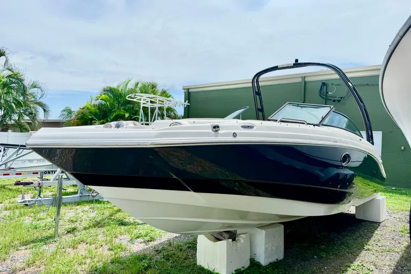 Slide: The Image of 2019 NauticStar 243 DC boat on display, featuring sleek design and black hull. - 3