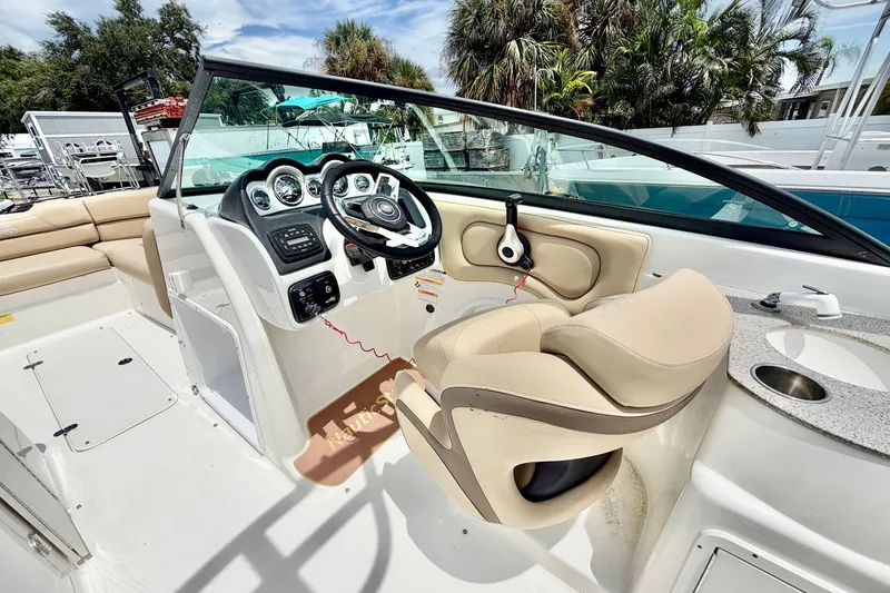 Slide: The Image of 2019 NauticStar 243 DC boat interior with steering wheel, dashboard, and seating. - 10
