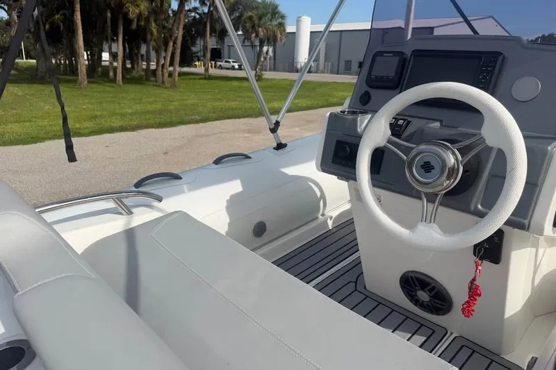 Slide: The Image of Interior of 2023 Grand G420 boat showing steering wheel and dashboard controls. - 7