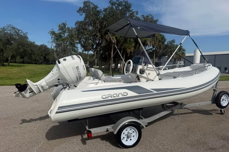 Slide: The Image of 2023 Grand G420 inflatable boat with Suzuki outboard motor on trailer. - 4
