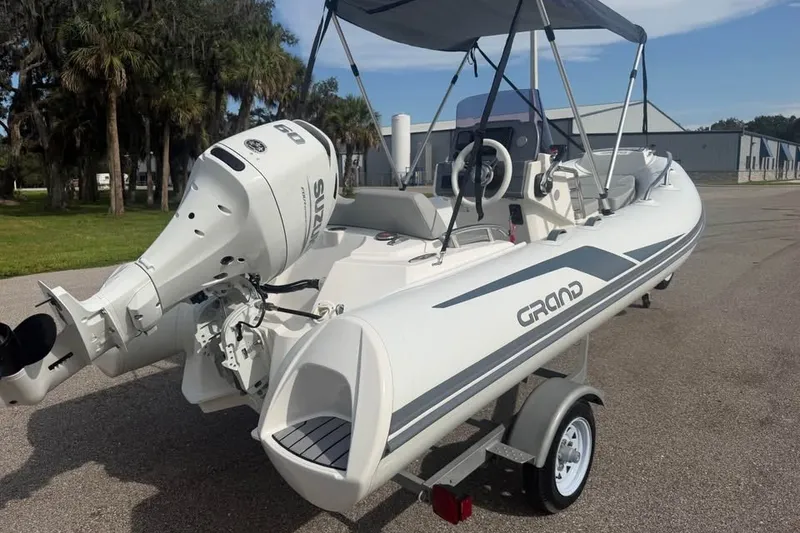 Slide: The Image of 2023 Grand G420 inflatable boat with outboard motor on a trailer. - 2