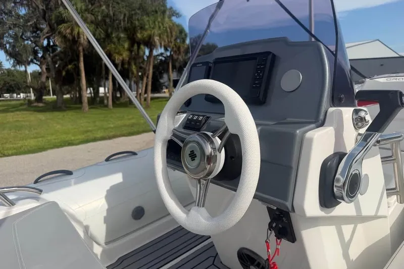 Slide: The Image of Steering console of 2023 Grand G420 boat with modern controls and white wheel. - 6