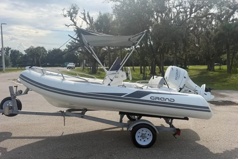 Slide: The Image of 2023 Grand G420 inflatable boat on trailer with Suzuki outboard motor. - 11