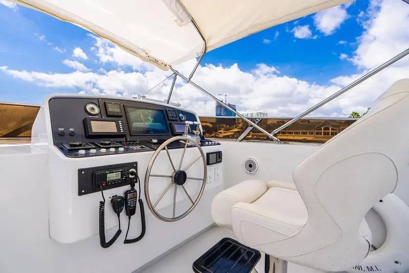 Slide: The Image of Intermarine Raised Pilothouse 2001 yacht helm with navigation equipment and white captain's chair. - 24