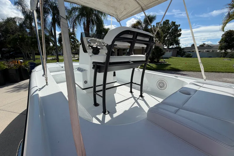 Slide: The Image of 2018 Yellowfin 21 Bay boat interior with seating and steering console under canopy. - 30