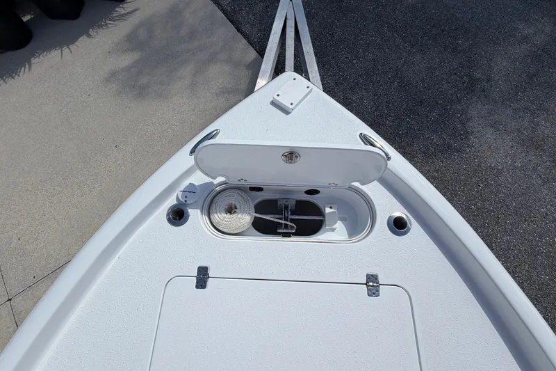Slide: The Image of Bow of 2018 Yellowfin 21 Bay boat with open storage compartment and anchor. - 37