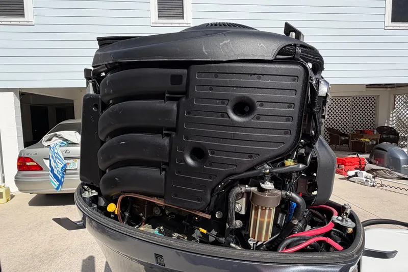 Slide: The Image of 2018 Yellowfin 21 Bay boat engine, detailed view in a residential driveway. - 14