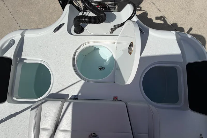Slide: The Image of 2018 Yellowfin 21 Bay boat deck with open storage compartments and seating. - 19
