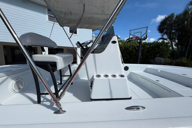 Slide: The Image of 2018 Yellowfin 21 Bay boat interior with seating and console, under a clear blue sky. - 31