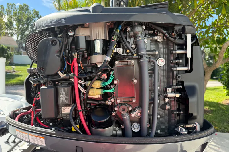 Slide: The Image of Close-up of a 2018 Yellowfin 21 Bay boat engine, showcasing intricate wiring and components. - 12