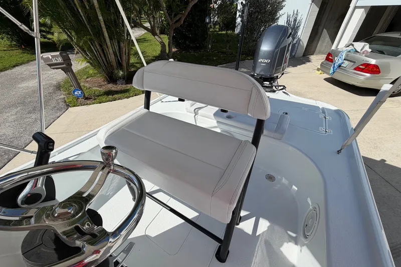 Slide: The Image of 2018 Yellowfin 21 Bay boat interior with steering wheel and seating. - 29