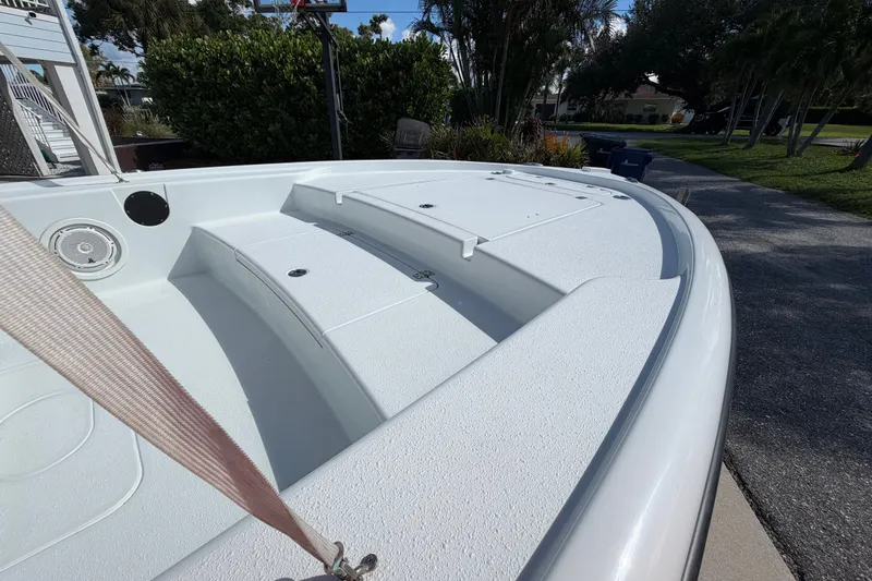 Slide: The Image of 2018 Yellowfin 21 Bay boat deck, white interior, outdoor setting. - 42