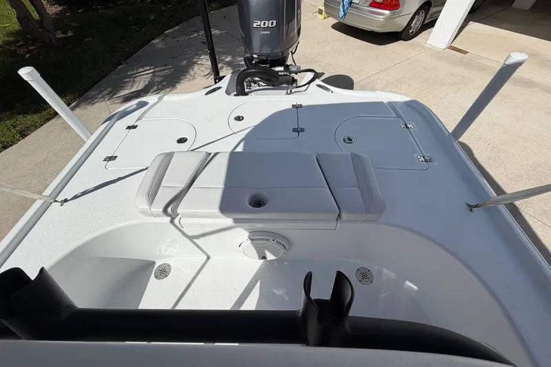 Slide: The Image of 2018 Yellowfin 21 Bay boat deck with Yamaha 200 engine, parked in driveway. - 18