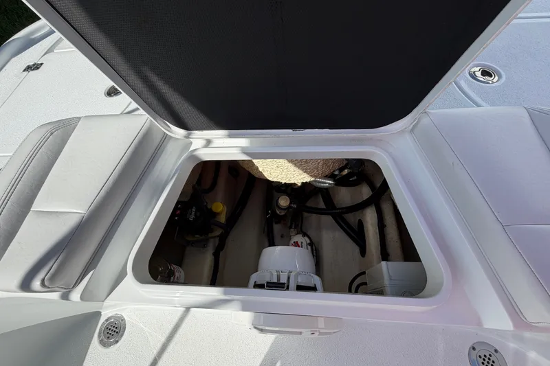 Slide: The Image of Open hatch of 2018 Yellowfin 21 Bay boat showing internal components and storage. - 23