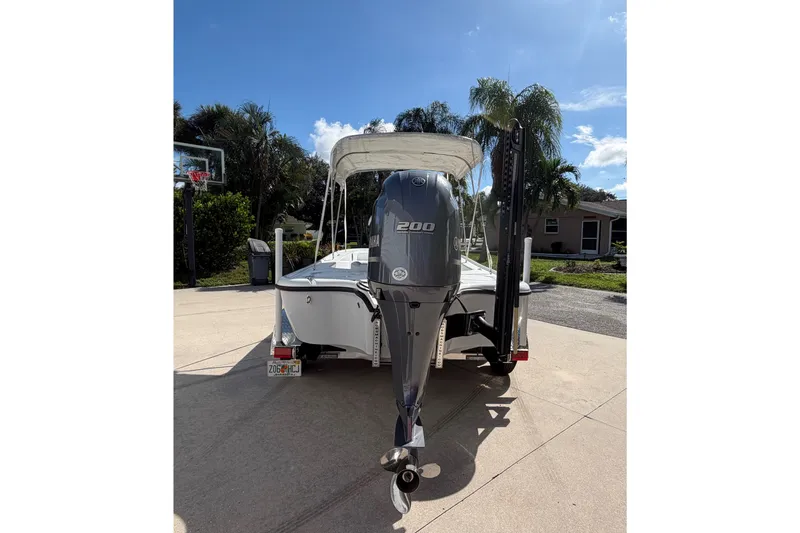 Slide: The Image of 2018 Yellowfin 21 Bay boat with 200 HP engine, parked in driveway. - 9